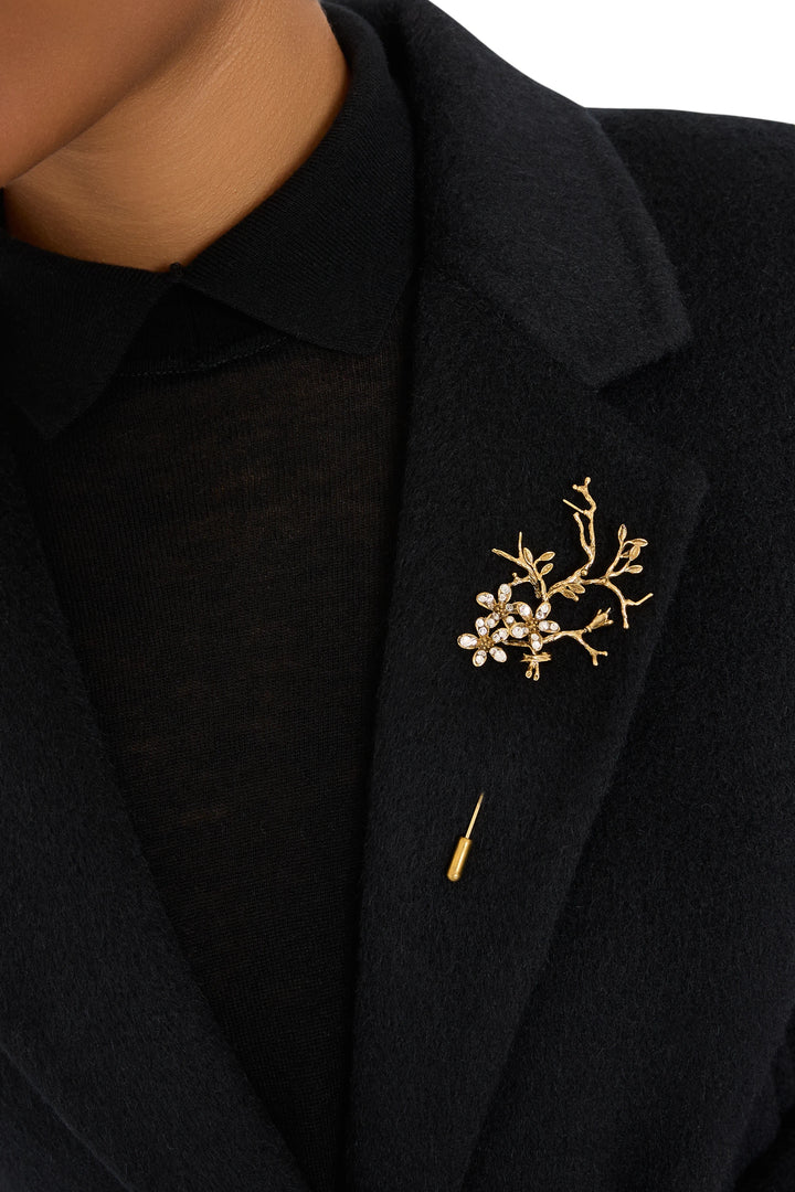 Branch-shaped brooch with gold-tone finish, sculpted details, Bloom Pin. Front view on white.
