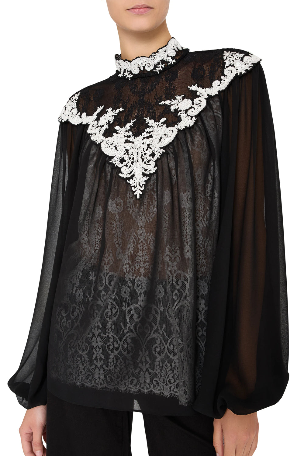 Sheer blouse with relaxed silhouette, artisanal lace embroidery, scalloped hem. Front view on white.