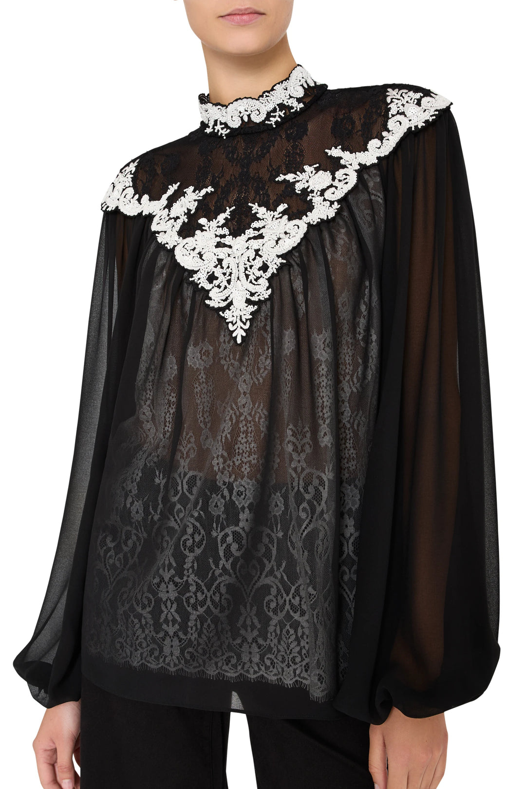 Sheer blouse with relaxed silhouette, artisanal lace embroidery, scalloped hem. Front view on white.