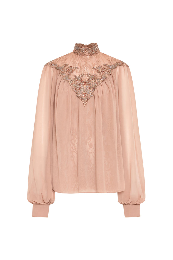 Sheer blush lace blouse, high neck, beaded lace at neck, chest and cuffed sleeves. Front view on white.