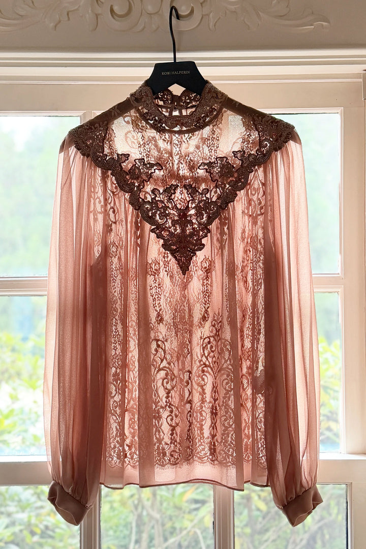Sheer blouse with long sleeves, antique lace details, soft silhouette; front view on white.