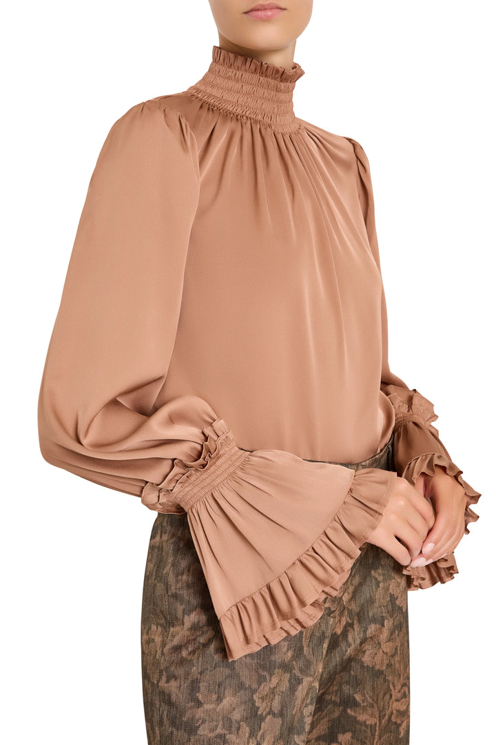 Maxine Silk High Neck Blouse with smocked neckline, flared cuffs, and elastic detailing, side view on model.