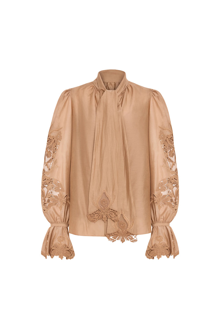 Light brown silk-cotton blouse with puffed sleeves, tie neckline, antique-inspired embroidery; front view on white.