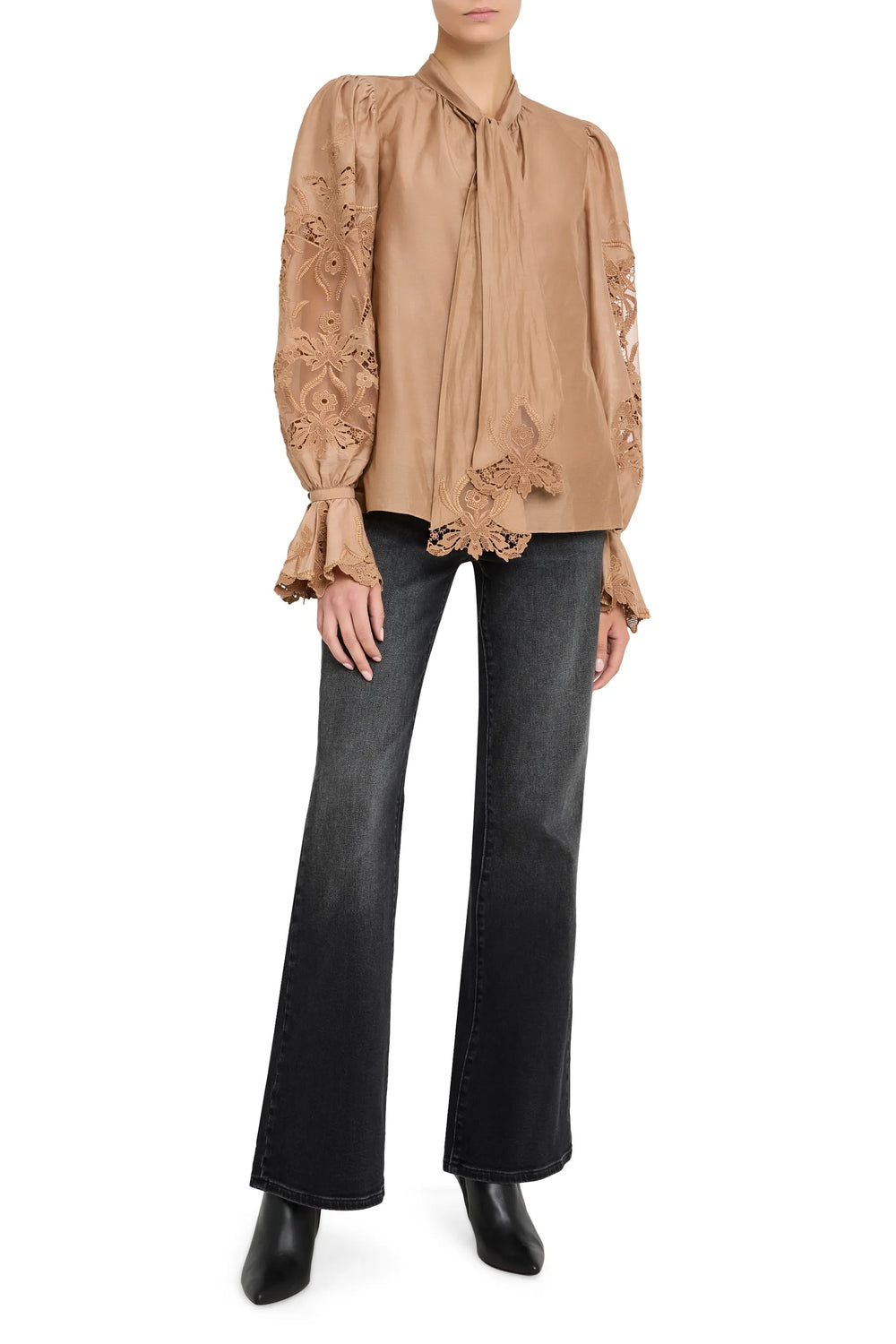 Sheer cotton blouse with bishop sleeves, hand embroidery, pintucked bodice. Front view on model.
