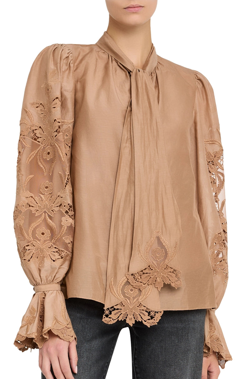 Lightweight cotton blouse with hand-embroidered detailing, relaxed silhouette, button front; front view on model.