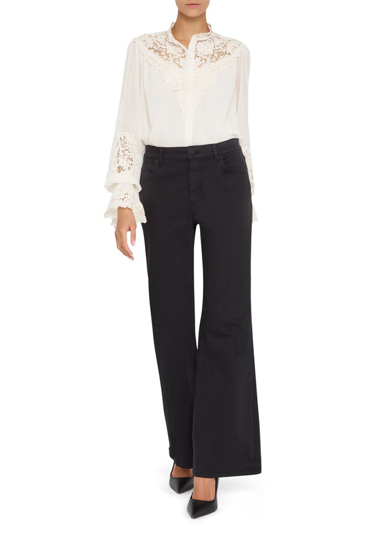 Semi-sheer blouse with hand-embroidered lace, pintucked bodice, and bishop sleeves; front view on model.