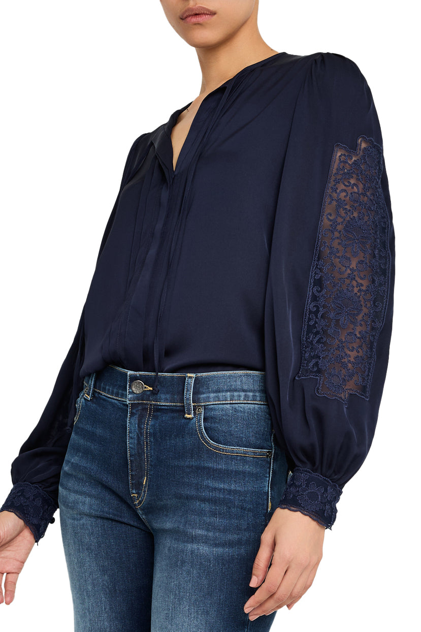 Silk blouse with lace trim, classic collar, relaxed fit, button front, long sleeves; front view on model.