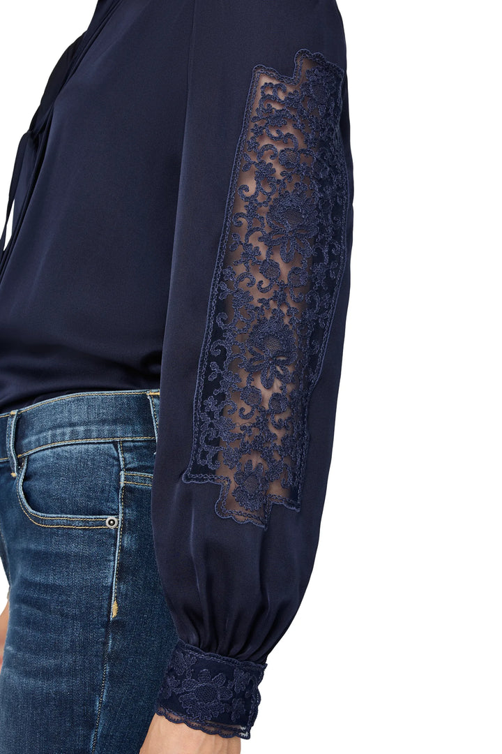 Silk blouse with lace panels, draped silhouette, long sleeves, side view on model.