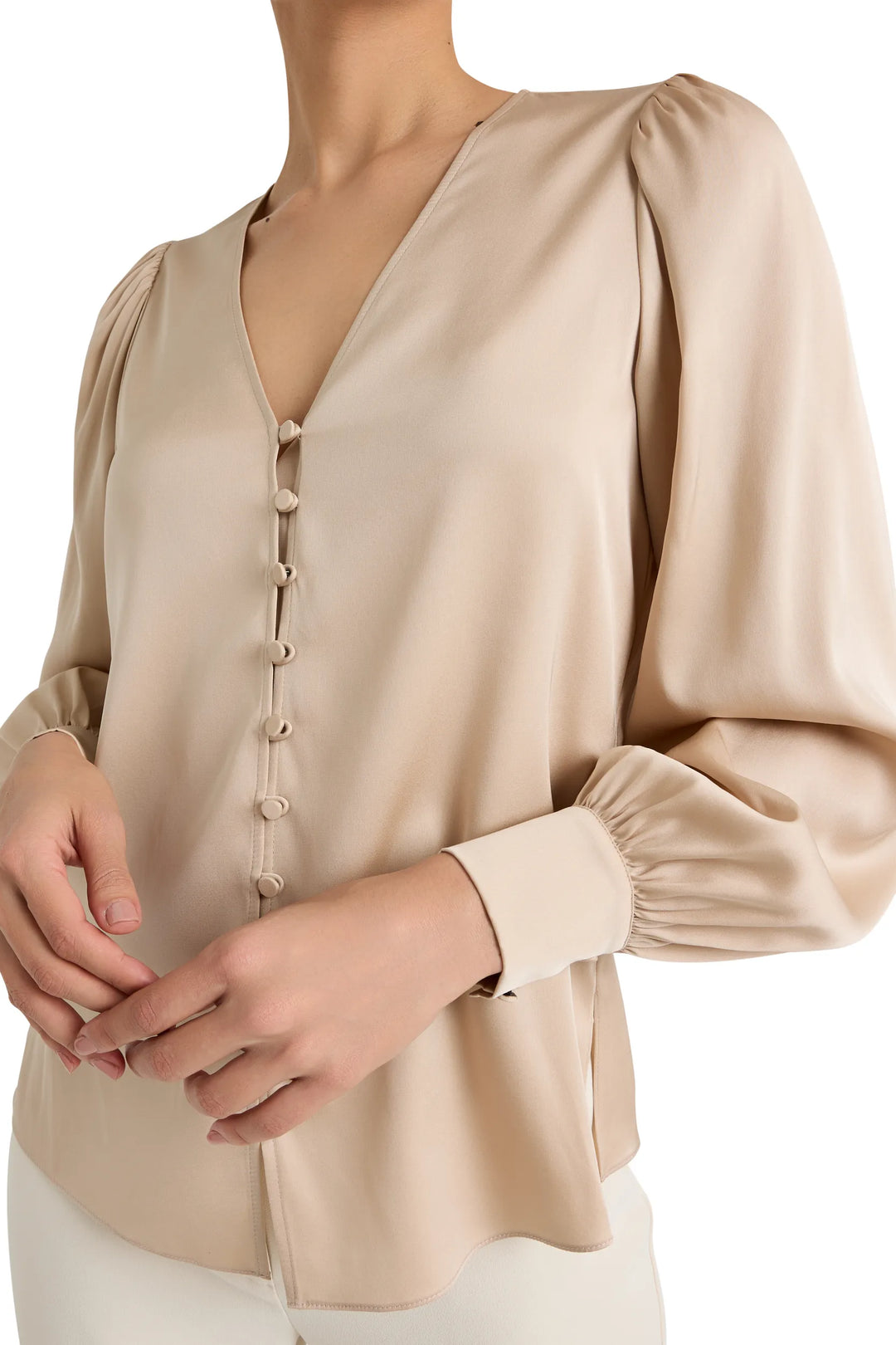 Stretch silk blouse with V-neck, button front, fabric-covered buttons, long balloon sleeves; front view on model.