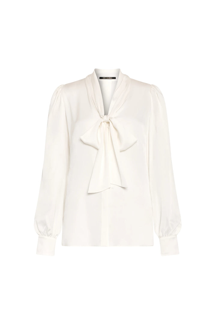 Fluid stretch silk georgette blouse with bow tie neck, buttoned cuffs, soft drape; front view on white.