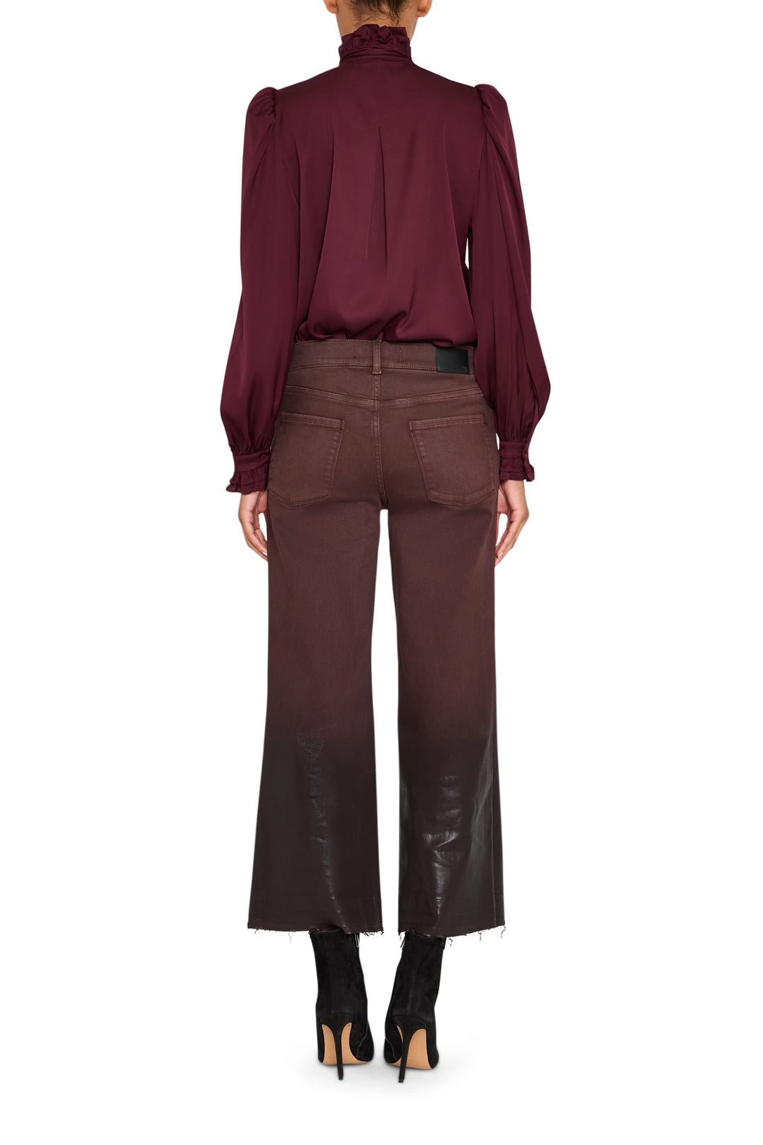 Silk blouse with ruffled neckline and sleeves, fluid silhouette, shown in back view on model.
