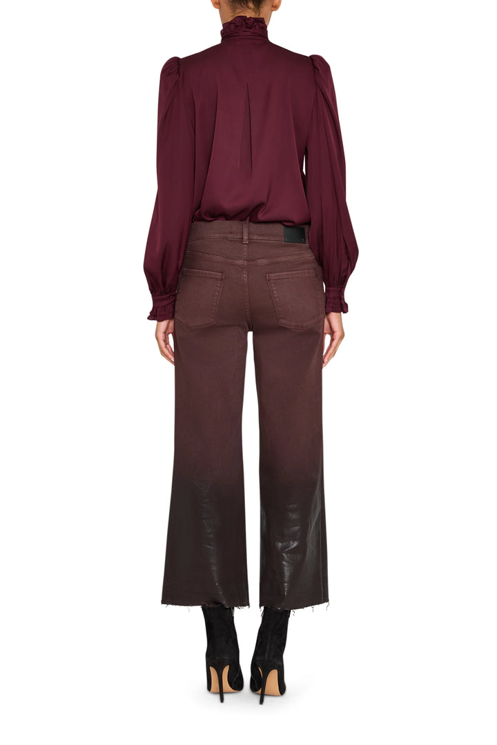 Silk blouse with ruffled neckline and sleeves, fluid silhouette, shown in back view on model.
