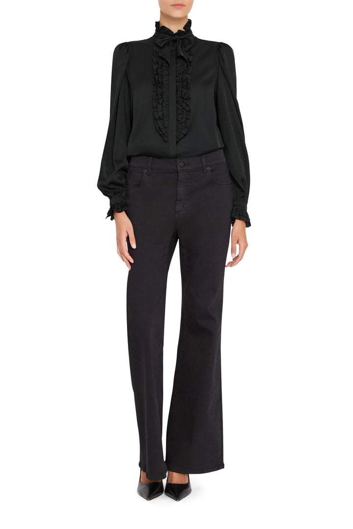 Silk blouse with ruffle front, high collar, and button placket. Voluminous sleeves. Front view on model.