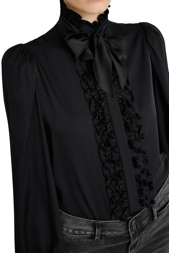 Silk blouse with ruffled front, bow tie collar, long sleeves, relaxed fit. Front view on model.