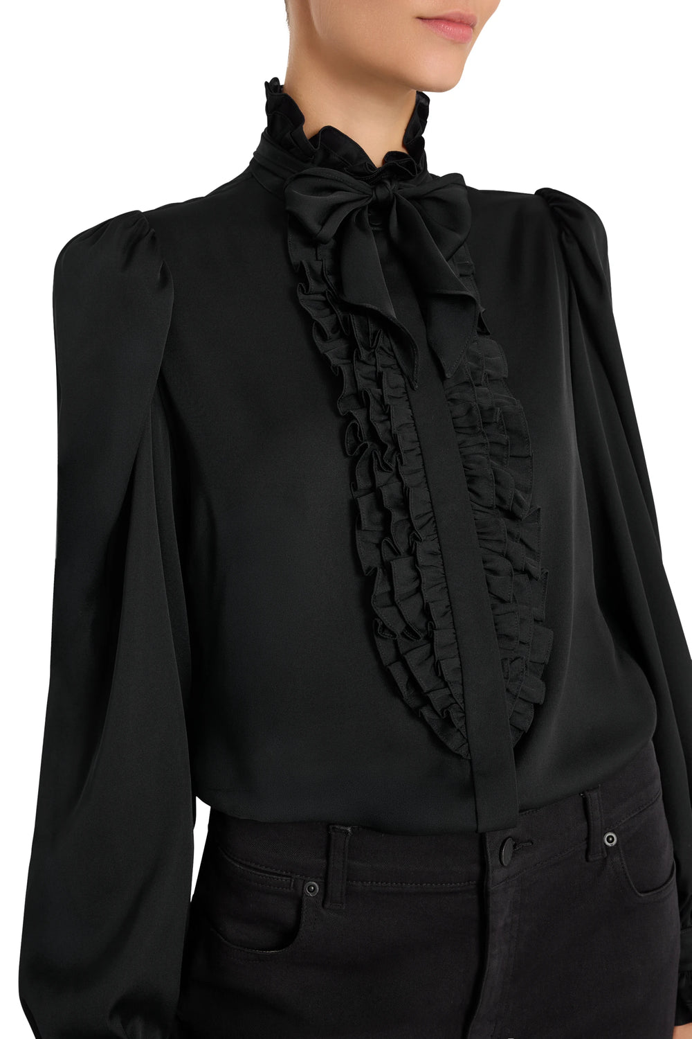 Silk blouse with ruffled bow neck and puffed sleeves, relaxed silhouette. Front view on model.