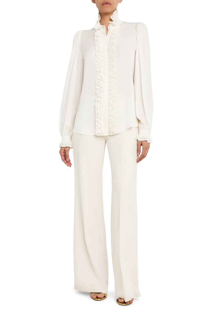 Long-sleeve silk blouse with ruffle detail and relaxed silhouette, front view on model.