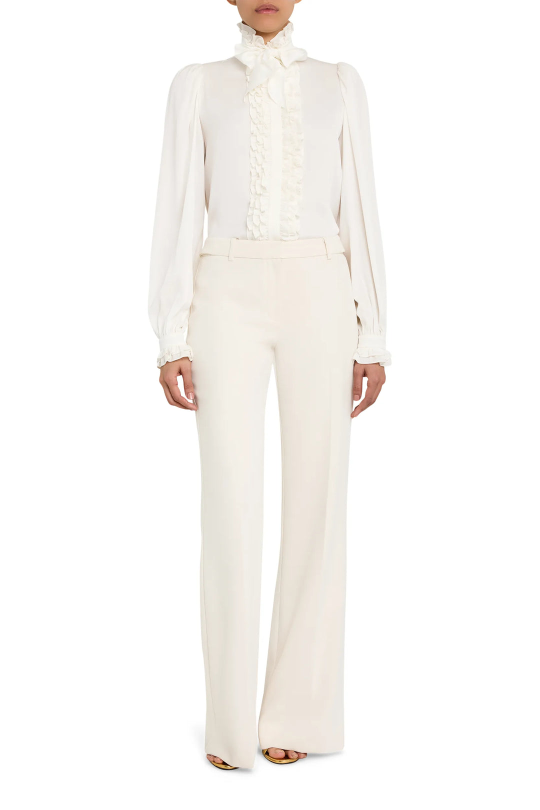 Silk ruffle blouse with long sleeves, high collar, and layered front ruffles. Front view on white.