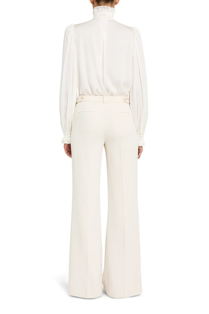 Silk blouse with ruffled detailing and relaxed silhouette, back view on model.