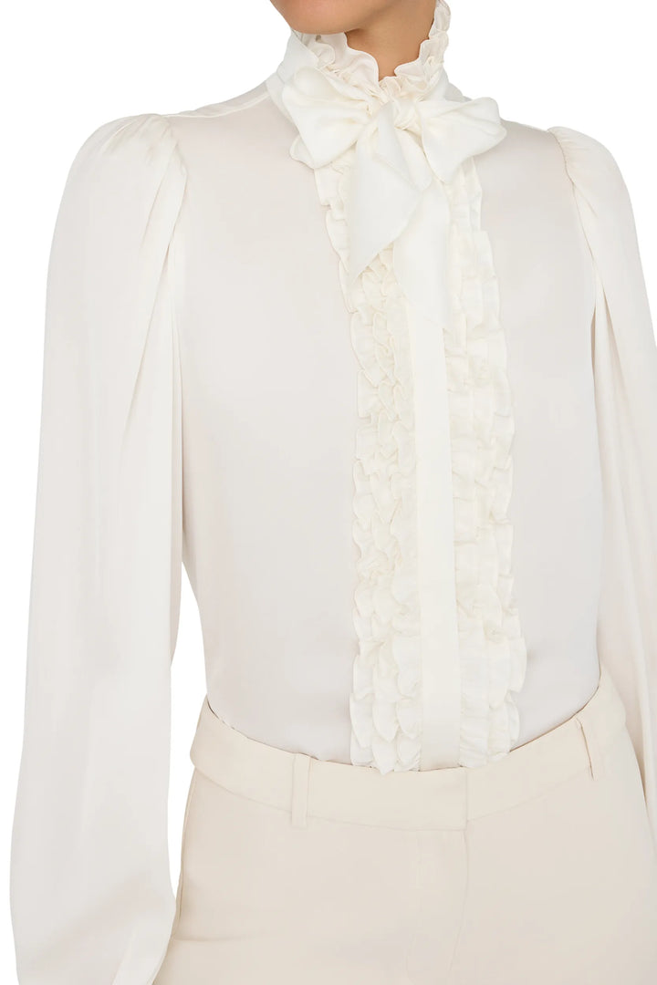 Silk blouse with ruffles, bow collar, relaxed silhouette, long sleeves. Front view on model.