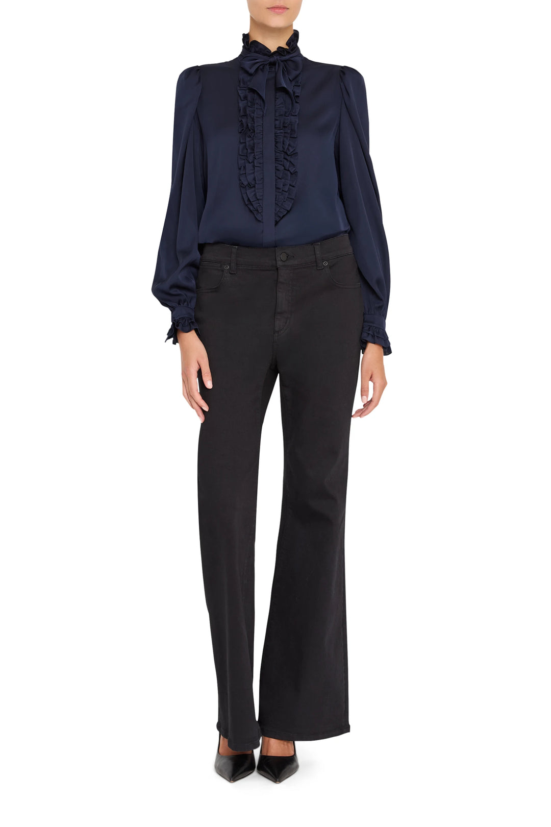 Silk blouse with ruffled front, fluid silhouette, button placket; front view on model.