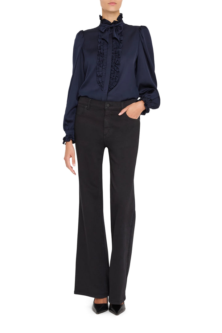 Silk blouse with ruffled front, long sleeves, and relaxed silhouette. Front view on model.