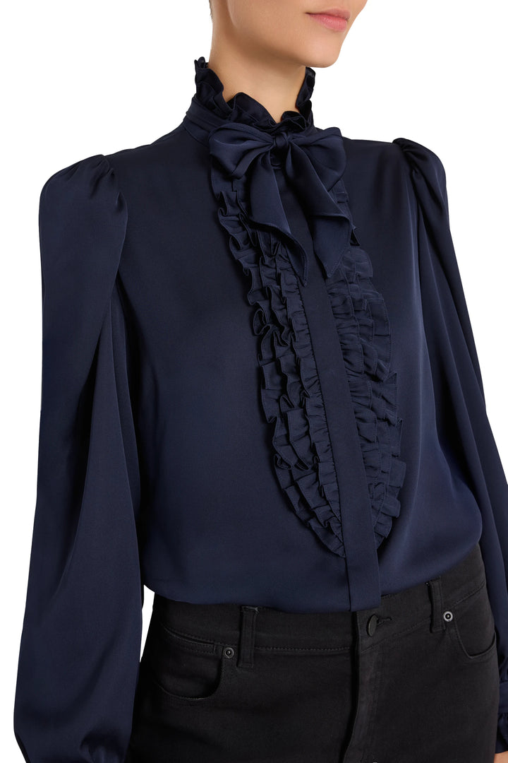 Silk blouse with ruffles, handkerchief tie, and puffed sleeves. Front view on model.