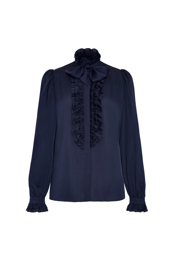 Long sleeve navy stretch silk blouse with ruffled front, high neck bow, ruffle cuffs; front view on white.