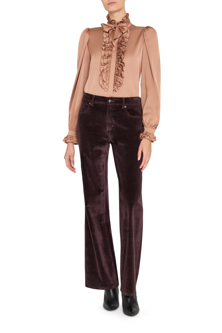Silk ruffle blouse with voluminous sleeves, gathered cuffs, and high neckline. Front view on white.