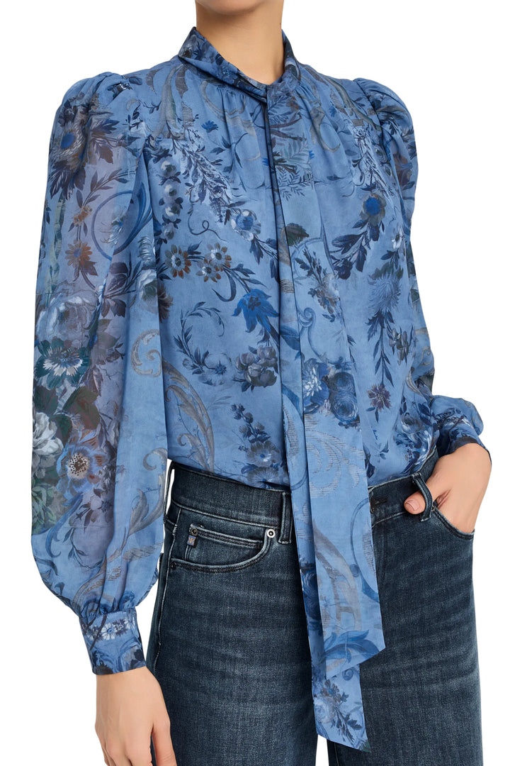 Long-sleeve blouse with relaxed silhouette, floral print, button front, shirttail hem; front view on model.