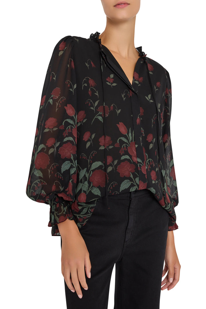 Chiffon blouse with bouquet prints, puffed sleeves, relaxed fit, soft drape. Front view on model.