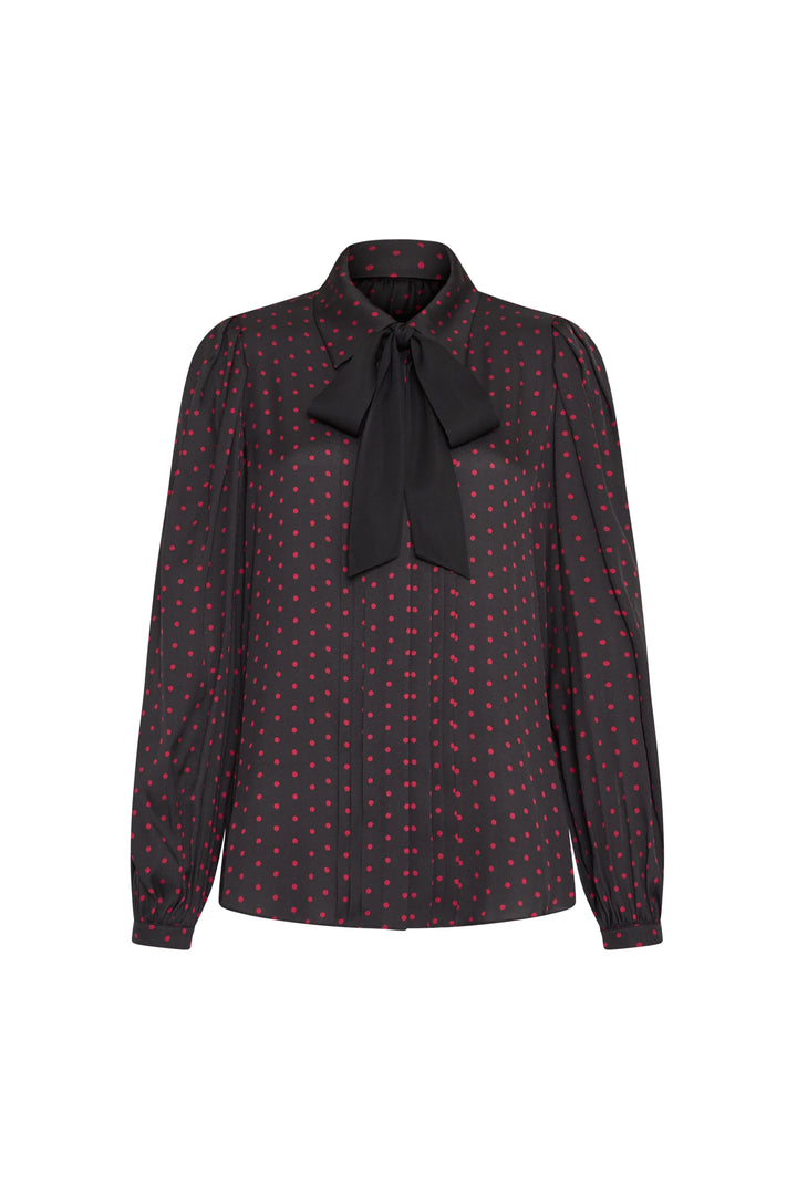 Silk blouse with polka dots, large bow collar, long sleeves, fluid silhouette. Front view on white.