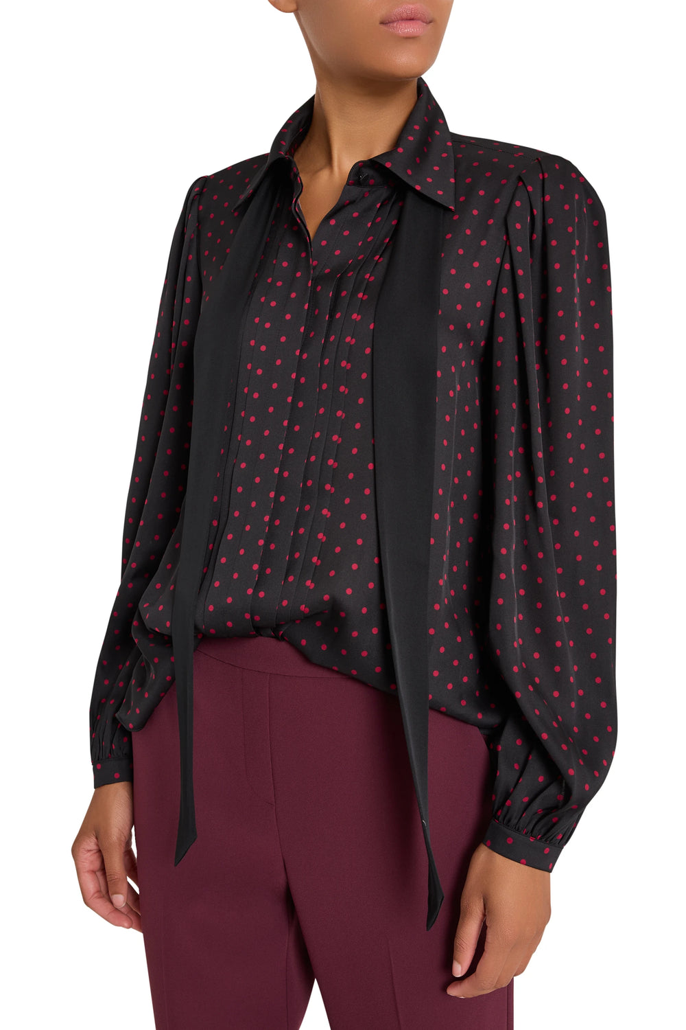 Silk blouse with polka dot print, button front, long sleeves, and loose removable tie; front view on model.