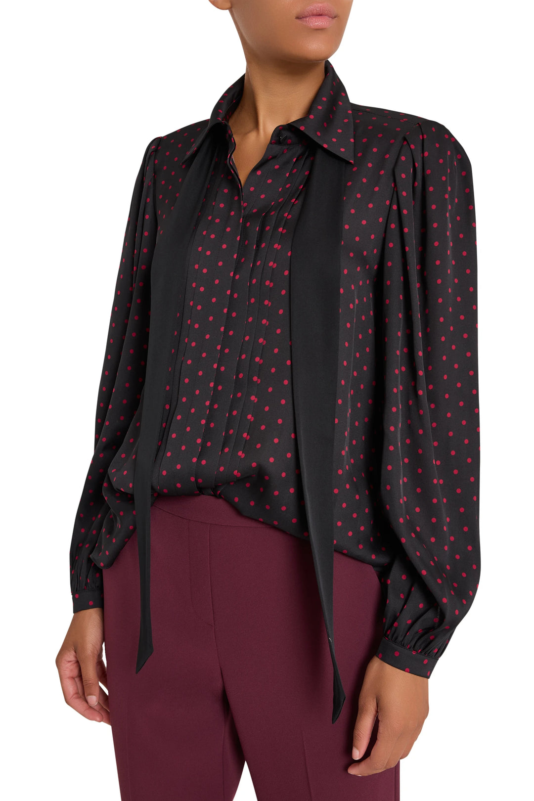 Silk blouse with polka dot print, button front, long sleeves, and loose removable tie; front view on model.