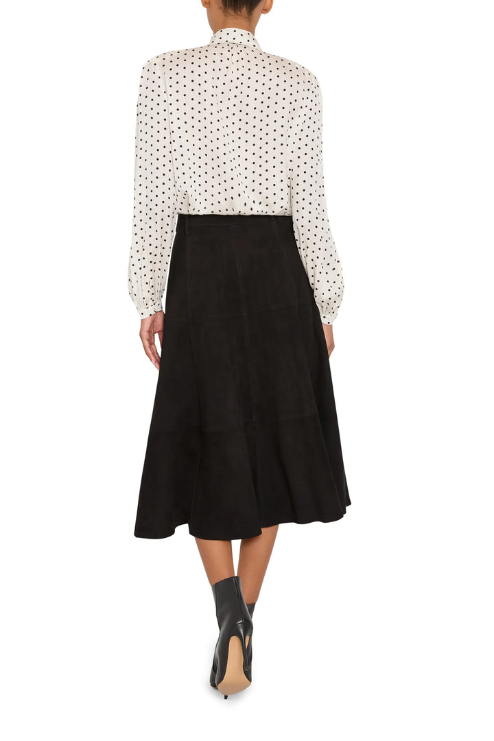 Silk blouse with relaxed fit, polka dot print, rounded hem, long sleeves; back view on model.