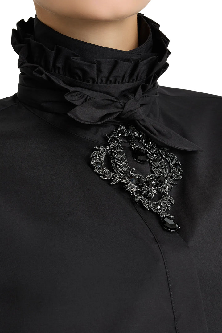High-neck cotton poplin shirt with tailored silhouette, structured neck detail; front view on model.