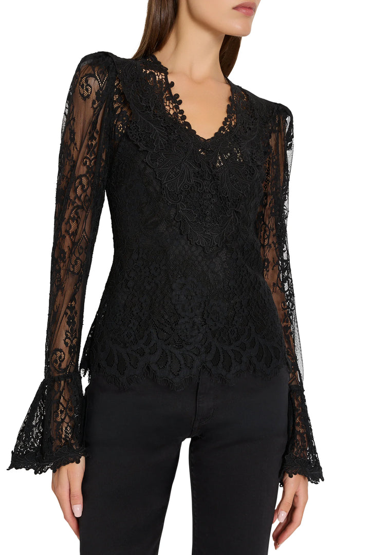 Callie Lace Blouse in black Chantilly lace with V-neck and puff sleeves, front view on model.