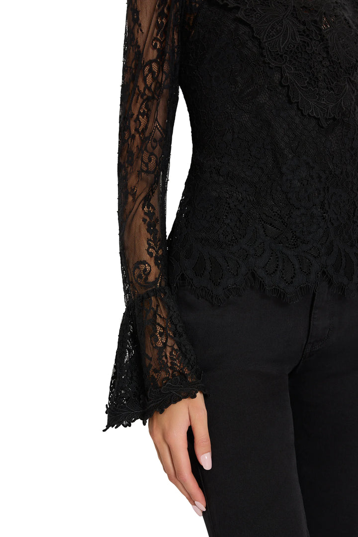 Callie Lace Blouse in black Chantilly lace with high neckline and long embroidered puff sleeves, side view on model.