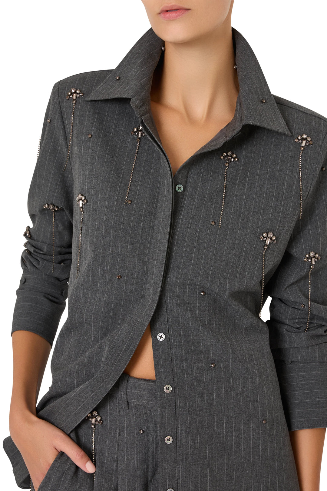 Button-up cotton shirt with vertical stripes, collar, front placket, and embellishment; front view on model.