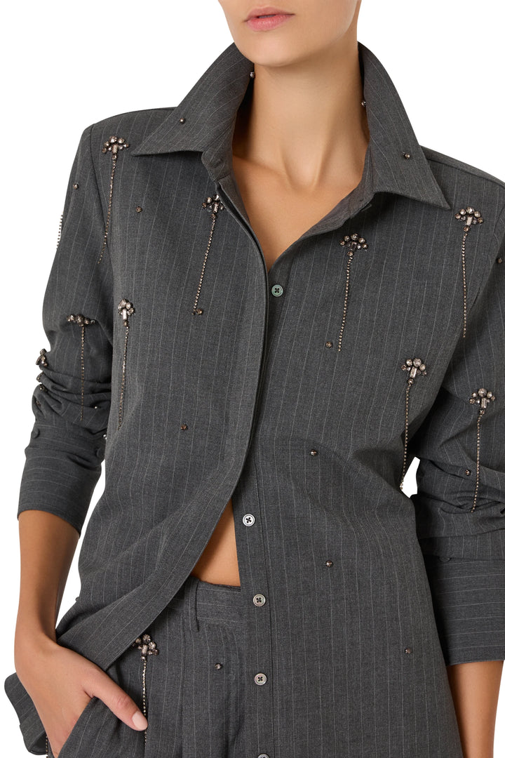 Button-up cotton shirt with vertical stripes, collar, front placket, and embellishment; front view on model.