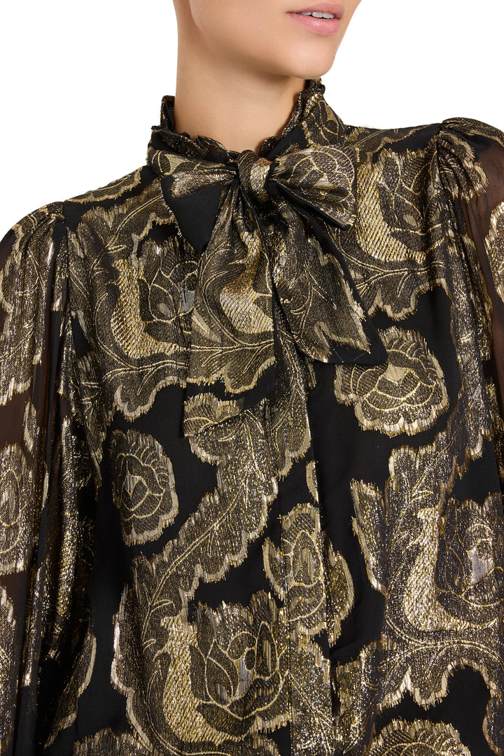 Niosha Lurex Jacquard Blouse, pussy-bow neck, puffed sleeves, black and gold metallic floral, front view on white.