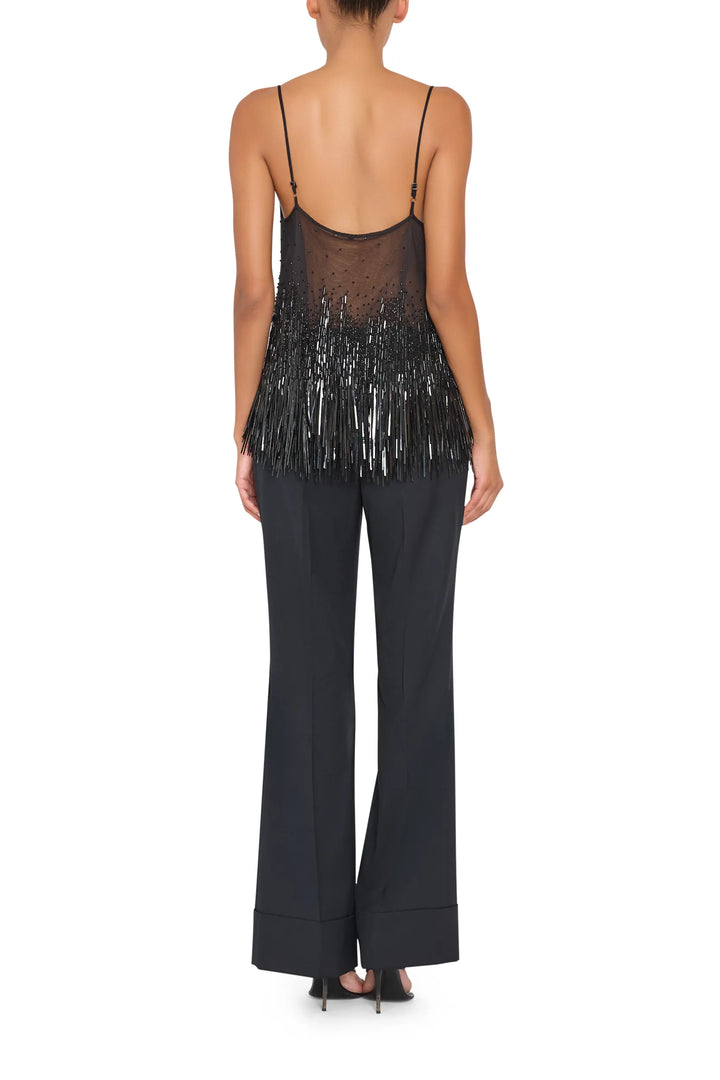 Sleeveless blouse with embellished back detail, straight silhouette, refined construction; back view on model.
