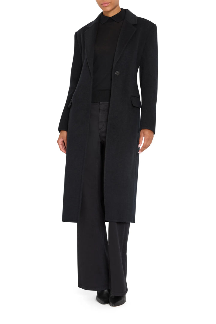 Long belted coat in wool silk with tailored silhouette and notch collar. Front view on white.