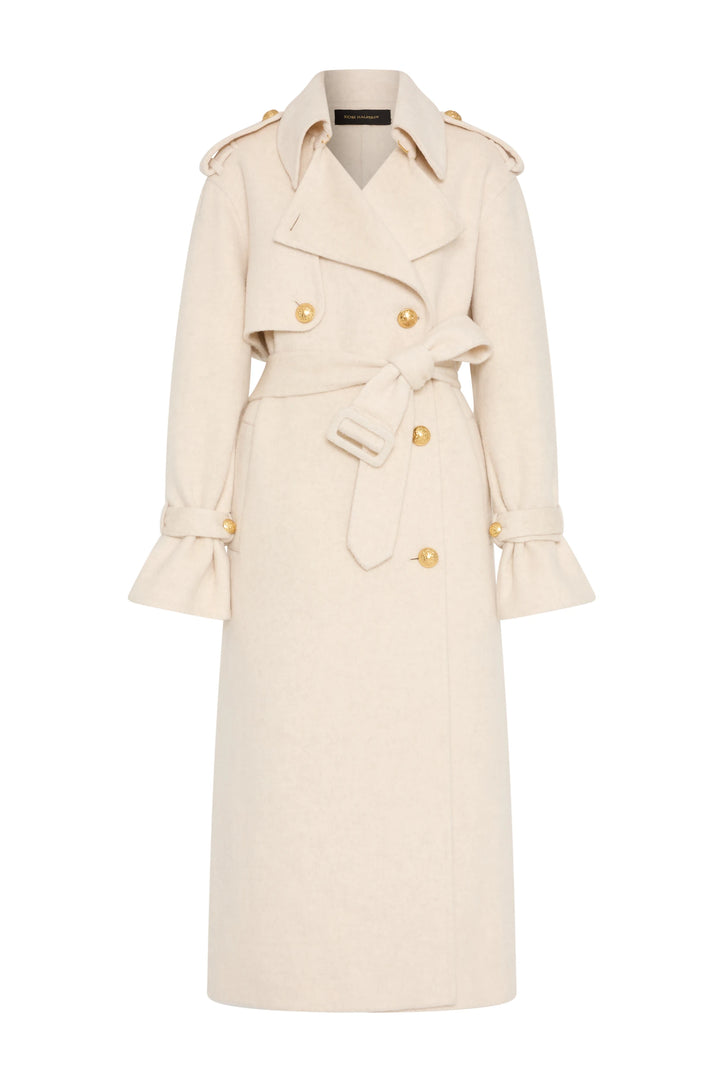 Cream silk wool trench coat, double-faced, gold buttons, belted waist, flared cuffs; front view on white.