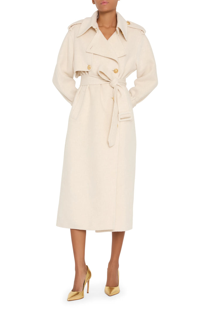 Longline silk wool trench coat with belted waist, military-inspired construction; front view on model.