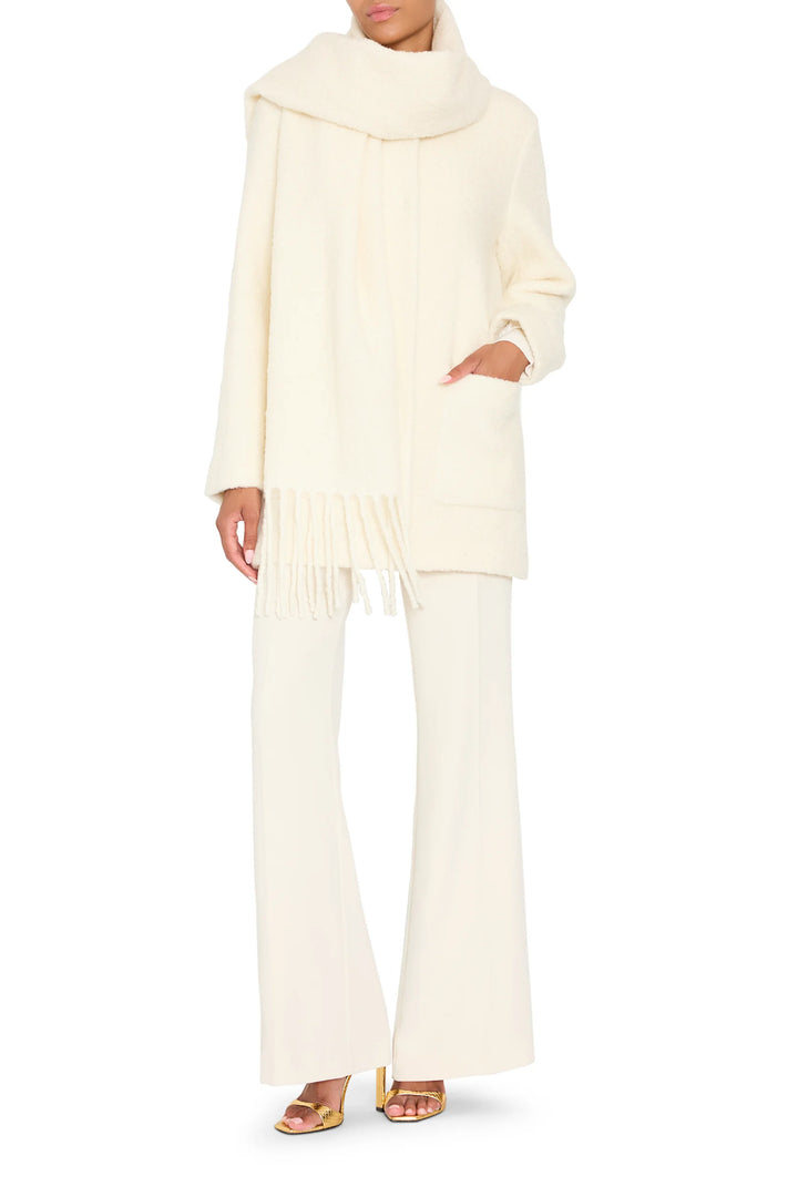 Longline bouclé coat with attached scarf, straight silhouette, subtle texture. Front view on model.