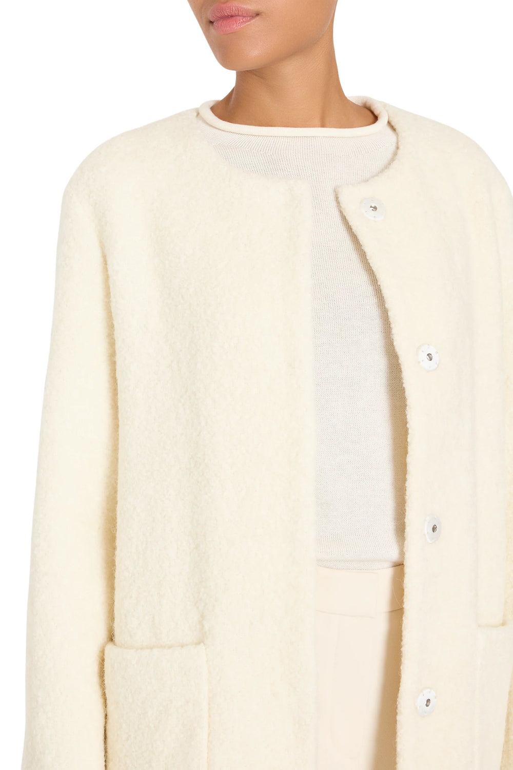 Textured bouclé coat with clean silhouette, tailored construction, minimal details; front view on model.