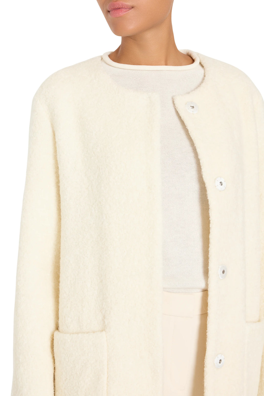 Textured bouclé coat with clean silhouette, tailored construction, minimal details; front view on model.