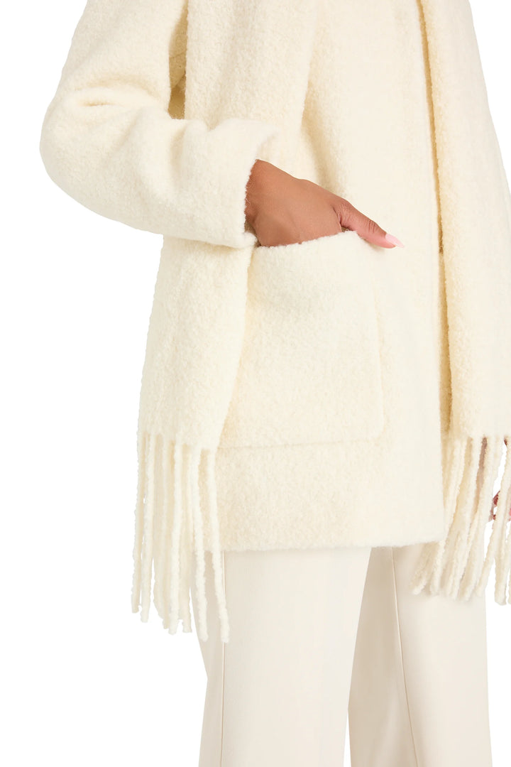 Longline cream bouclé coat with integrated scarf, straight silhouette and clean finish; front view on model.