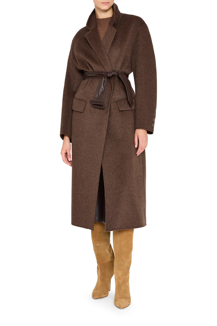 Long tailored coat in silk-wool blend with structured shoulders and self-tie vegan leather belt, front view on white.