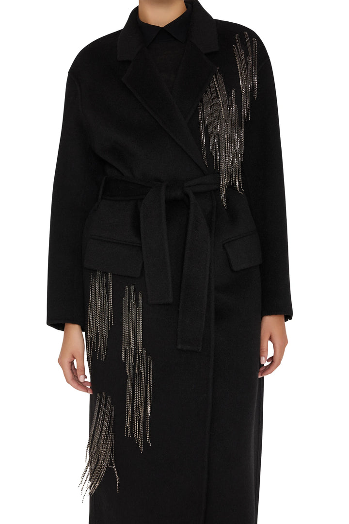 Long wool-blend coat, belted, silver bead fringe accents, tailored silhouette. Front view on white.